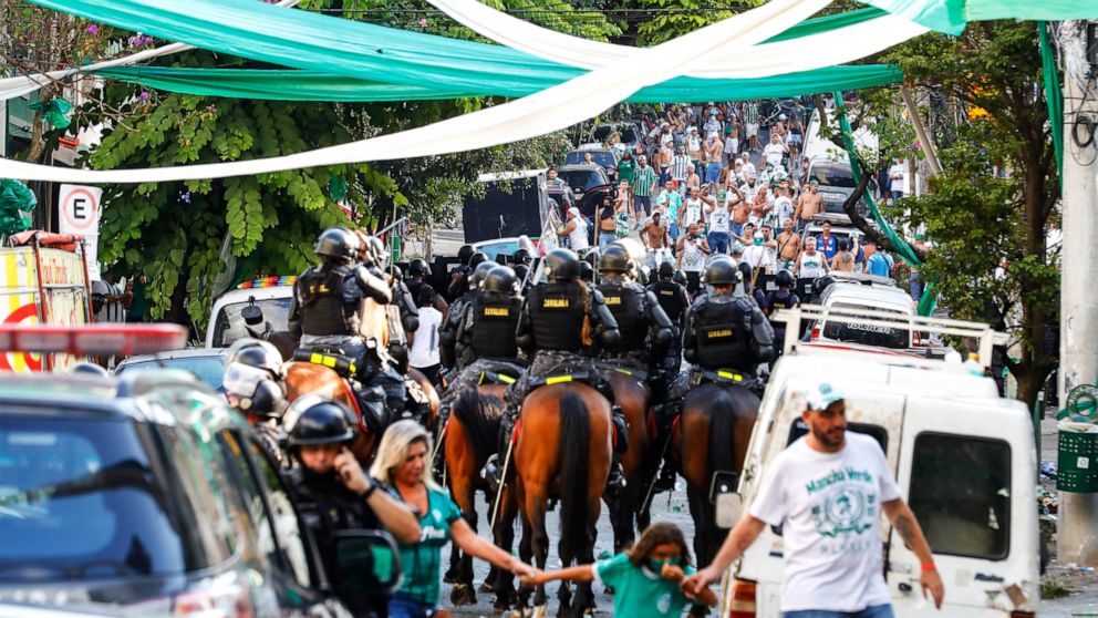 Riot police arrive to disperse dejected Palmeiras soccer club fans, who became rowdy after watching their team's defeat by Chelsea via a live broadcast, in Sao Paulo, Brazil, Saturday, Feb. 12, 2022. Chelsea went on to win the FIFA Club World Cup tit