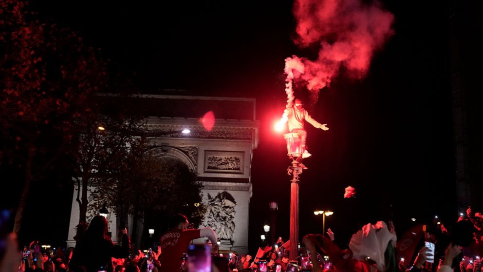 FILE - Morocco soccer fans celebrate their team's victory on the Champs-Elysees avenue after the World Cup quarterfinal soccer match between Morocco and Portugal Saturday, Dec. 10, 2022 in Paris. Every meeting of Morocco and France, the North African