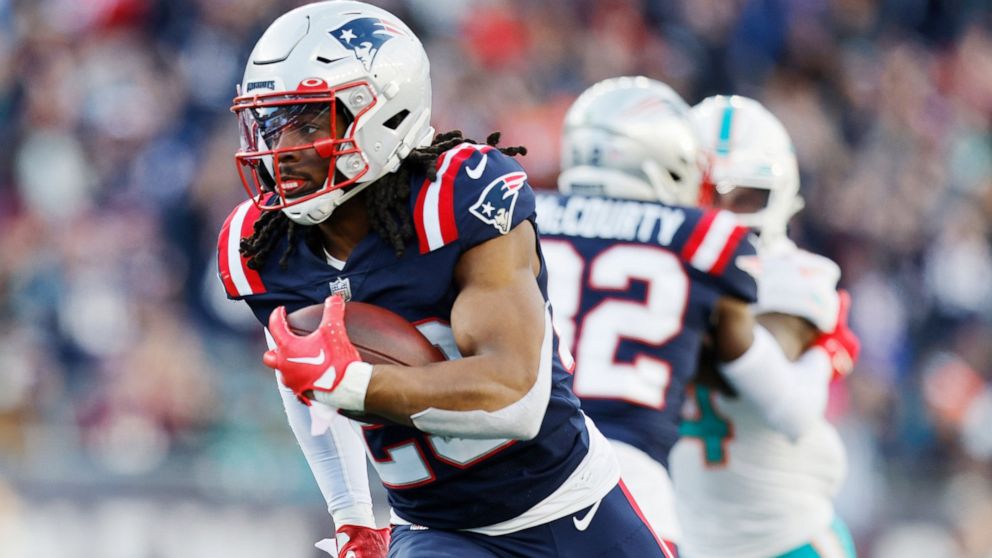 New England Patriots safety Kyle Dugger (23) heads towards the end zone, after intercepting the ball, on his touchdown run against the Miami Dolphins the during the second half of an NFL football game, Sunday, Jan. 1, 2023, in Foxborough, Mass. (AP P