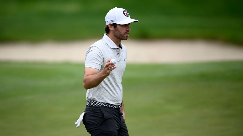 Matthew Wolff acknowledges the gallery after finishing on the 18th green during the first round of the Wells Fargo Championship golf tournament, Thursday, May 5, 2022, at TPC Potomac at Avenel Farm golf club in Potomac, Md. (AP Photo/Nick Wass)