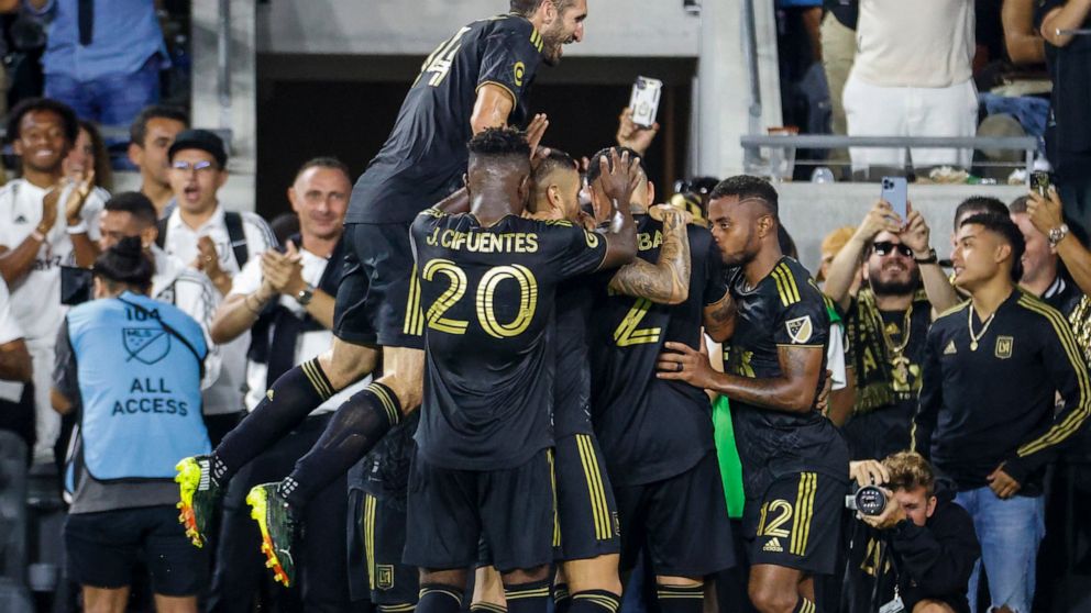 Los Angeles FC defender Giorgio Chiellini jumps to celebrate with teammates after forward Kwadwo Opoku scored against the Seattle Sounders during the first half of an MLS soccer match Friday, July 29, 2022, in Los Angeles. (AP Photo/Ringo H.W. Chiu)