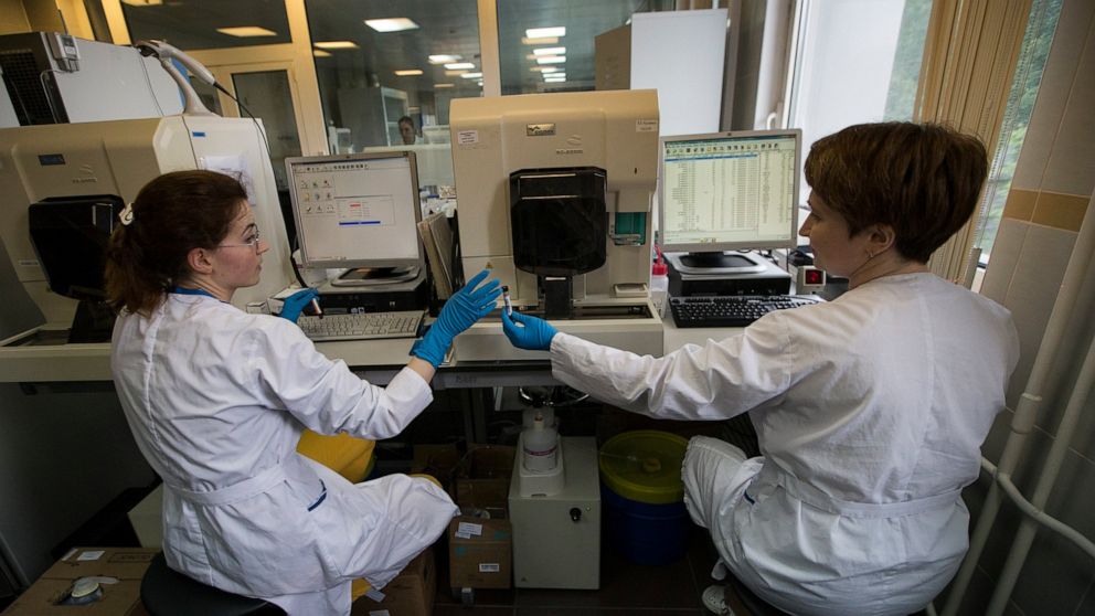 FILE - In this May 24, 2016 file photo, employees work in Russia's national drug-testing laboratory in Moscow, Russia. Russia is accused of manipulating an archive of doping data from a laboratory in Moscow, which was meant to be a peace offering to 
