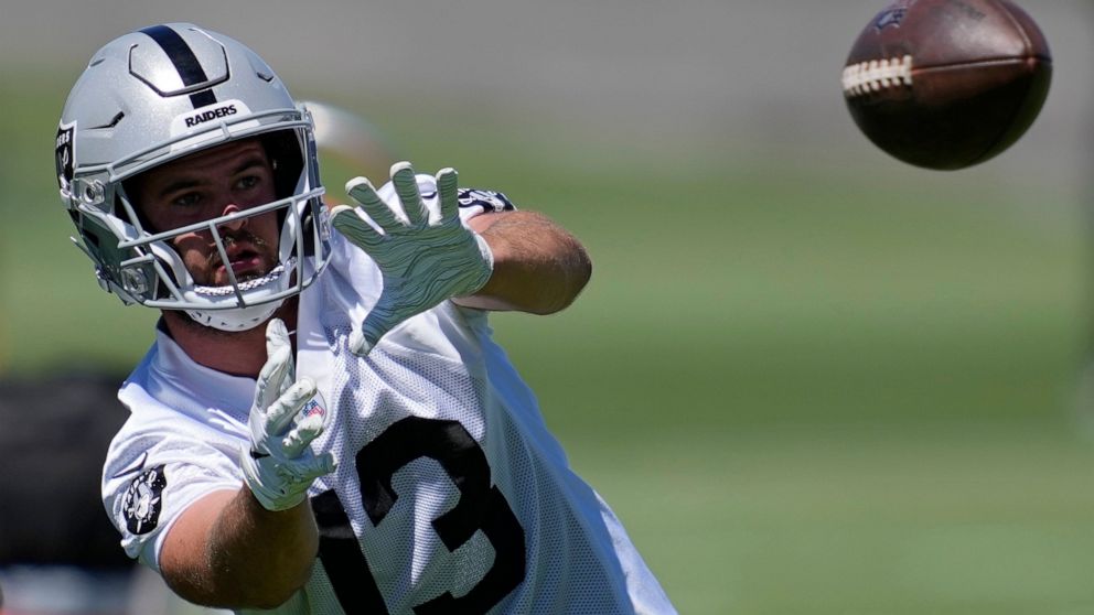 Las Vegas Raiders wide receiver Hunter Renfrow catches a pass during practice at the NFL football team's practice facility Thursday, June 2, 2022, in Henderson, Nev. (AP Photo/John Locher)