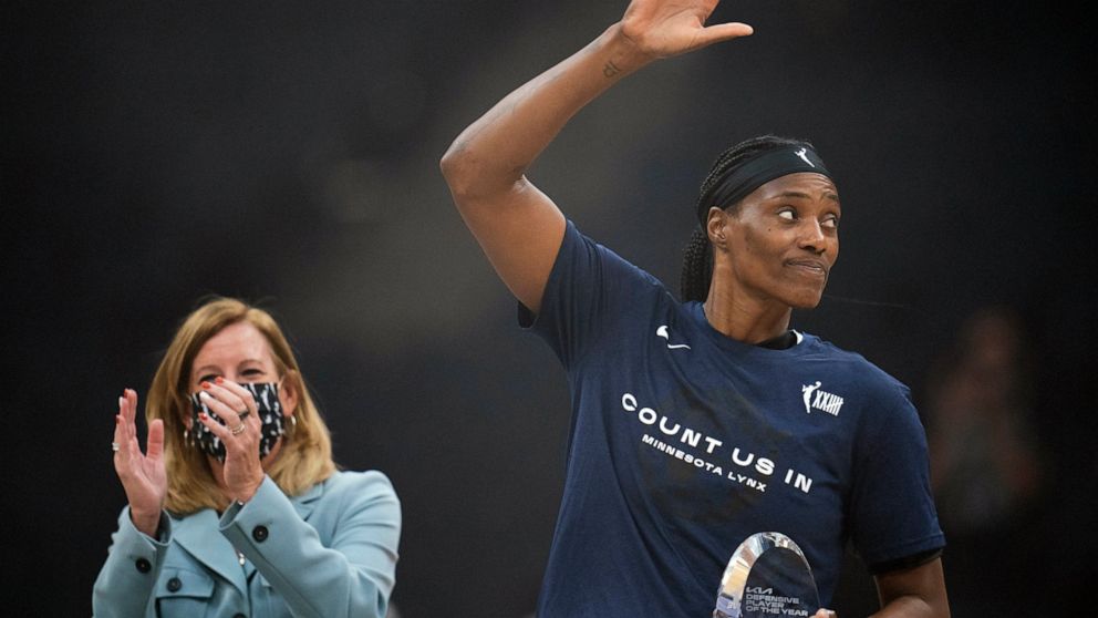 FILE - Minnesota Lynx center Sylvia Fowles waves to the crowd after WNBA commissioner Cathy Engelbert presented her with the trophy for being named WNBA Defensive Player of the Year, at a WNBA basketball game between the Lynx and Chicago Sky, Sunday,