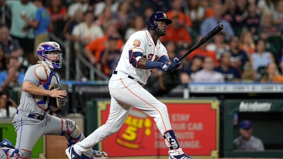 Houston Astros' Yordan Alvarez, right, watches his two-run home run along with New York Mets catcher Patrick Mazeika during the third inning of a baseball game Tuesday, June 21, 2022, in Houston. (AP Photo/David J. Phillip)