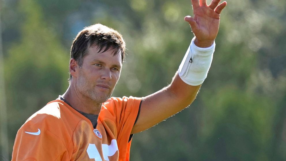 Tampa Bay Buccaneers quarterback Tom Brady waves to the fans during an NFL football training camp practice Wednesday, July 27, 2022, in Tampa, Fla. (AP Photo/Chris O'Meara)