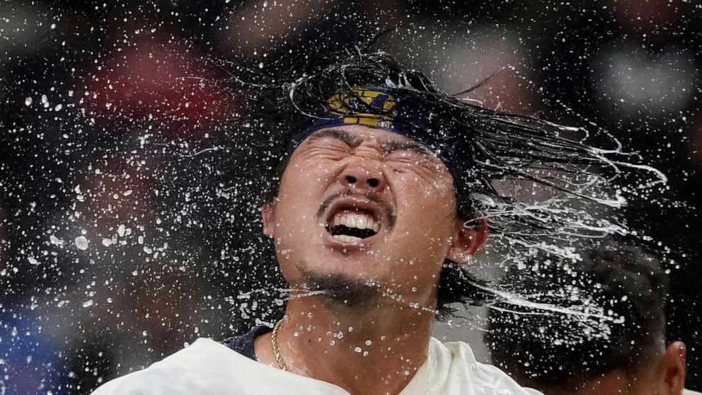 Milwaukee Brewers' Keston Hiura celebrates after hitting a walkoff two-run home run during the 11th inning of a baseball game against the Atlanta Braves Wednesday, May 18, 2022, in Milwaukee. The Brewers won 7-6. (AP Photo/Morry Gash)