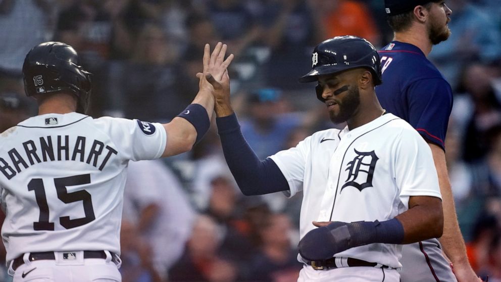 Detroit Tigers' Tucker Barnhart (15) greets Willi Castro after they both scored on a double by teammate Harold Castro during the fifth inning of a baseball game against the Minnesota Twins, Wednesday, June 1, 2022, in Detroit. (AP Photo/Carlos Osorio)