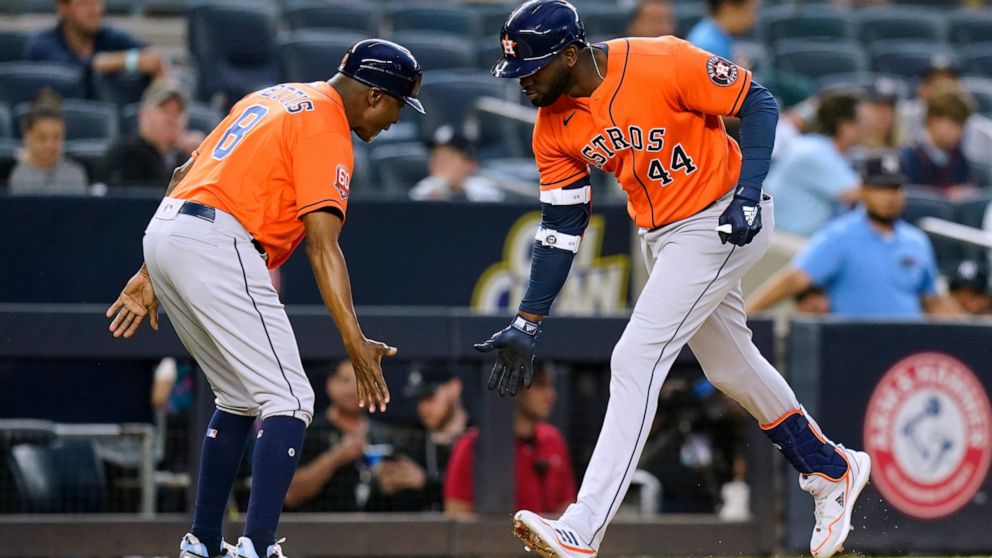 Houston Astros' Yordan Alvarez (44) celebrates with third base coach Gary Pettis as he runs the bases after hitting a three-run home run against the New York Yankees during the third inning of a baseball game Thursday, June 23, 2022, in New York. (AP