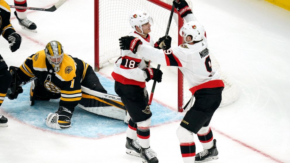 Ottawa Senators left wing Tim Stützle (18) is congratulated by Josh Norris, right, after his goal off Boston Bruins goaltender Jeremy Swayman (1) during the second period of an NHL hockey game, Thursday, April 14, 2022, in Boston. (AP Photo/Charles Krupa)