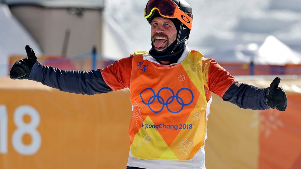 FILE - Nick Baumgartner, of the United States, celebrates after his run during the men's snowboard cross semifinals at Phoenix Snow Park at the 2018 Winter Olympics in Pyeongchang, South Korea, Feb. 15, 2018. On Thursday, Feb. 10, 2022, Baumgartner, 