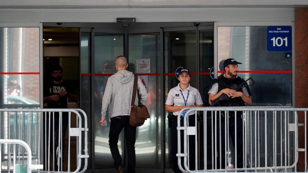 Police officers guard the Anti-Corruption Office of the Judicial Police headquarters in Nanterre, outside Paris,Tuesday, June 18, 2019. Former UEFA president Michel Platini has been arrested in relation to a corruption probe into the awarding of the 