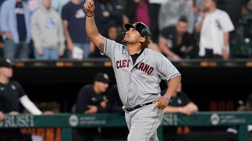Cleveland Guardians' Josh Naylor celebrates his game-tying grand slam off Chicago White Sox relief pitcher Liam Hendriks during the ninth inning of a baseball game Monday, May 9, 2022, in Chicago. (AP Photo/Charles Rex Arbogast)