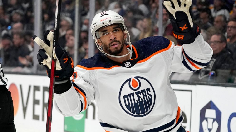 Edmonton Oilers left wing Evander Kane gestures after scoring an empty net goal during the third period in Game 6 of an NHL hockey Stanley Cup first-round playoff series against the Los Angeles Kings Thursday, May 12, 2022, in Los Angeles. (AP Photo/