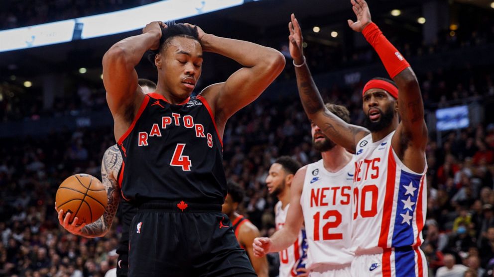 Toronto Raptors forward Scottie Barnes (4) reacts after being fouled by Brooklyn Nets forward Royce O'Neale (00) during the first half of an NBA basketball game in Toronto, Friday, Dec. 16, 2022. (Cole Burston/The Canadian Press via AP)