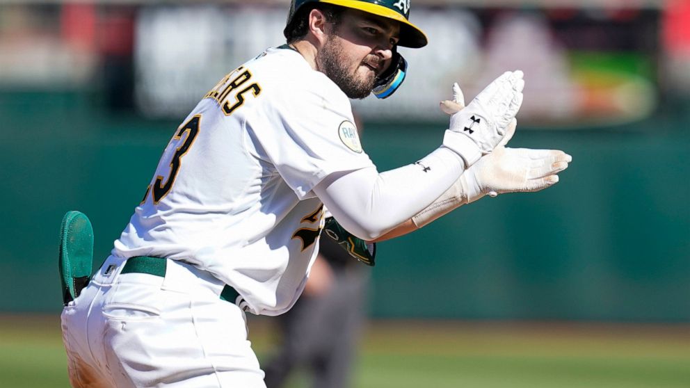 Oakland Athletics' Shea Langeliers celebrates after hitting an RBI-triple against the Seattle Mariners during the eighth inning of a baseball game in Oakland, Calif., Sunday, Aug. 21, 2022. (AP Photo/Godofredo A. Vásquez)