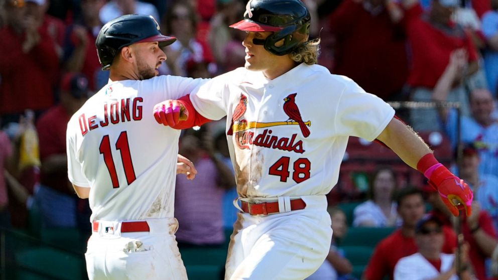 St. Louis Cardinals' Harrison Bader (48) is congratulated by teammate Paul DeJong (11) after hitting a two-run home run during the seventh inning of a baseball game against the Arizona Diamondbacks Sunday, May 1, 2022, in St. Louis. (AP Photo/Jeff Ro