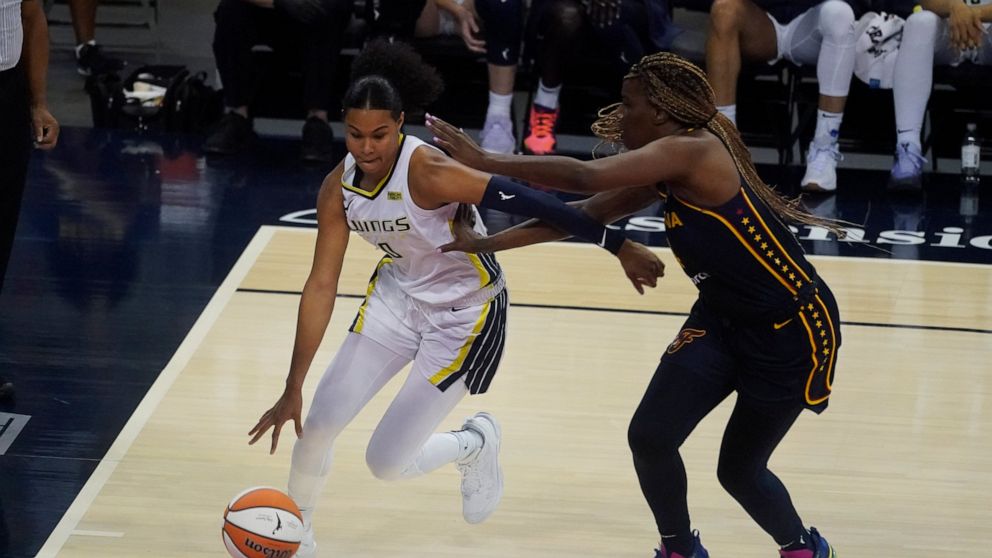 Dallas Wings' Satou Sabally (0) goes to the basket against Indiana Fever's Jantel Lavender (14) during the second half of a WNBA basketball game, Thursday, June 24, 2021, in Indianapolis. (AP Photo/Darron Cummings)