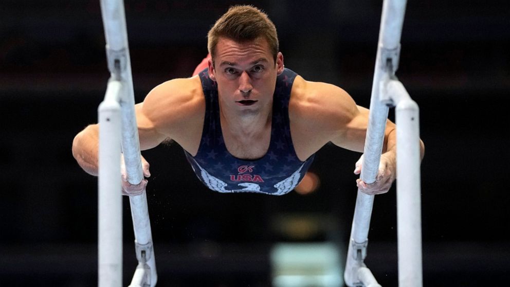 FILE - In this June 26, 2021, file photo, Sam Mikulak competes on the parallel bars during the men's U.S. Olympic Gymnastics Trials in St. Louis. On the eve of the Tokyo Games, it’s clear that just arriving at this point for some of the world’s great