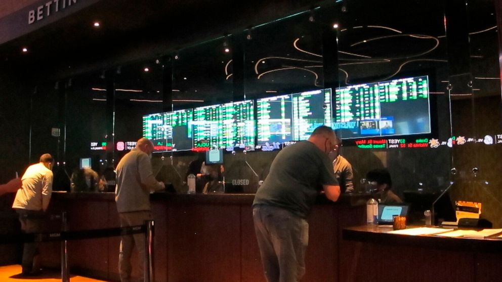 FILE - People line up to make sports bets at the Borgata casino in Atlantic City, N.J., March 19, 2021. Gambling has gone from the forbidden topic in the NFL to a key part of the league's present and future. The days of lobbying against widespread le