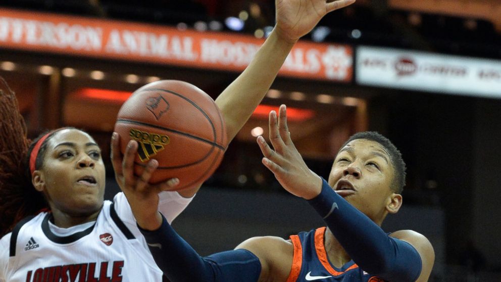 Virginia guard Dominique Toussaint (4) goes in for a layup past Louisville forward Bionca Dunham (33) during the first half of an NCAA college basketball game in Louisville, Ky., Thursday, Jan. 17, 2019. (AP Photo/Timothy D. Easley)