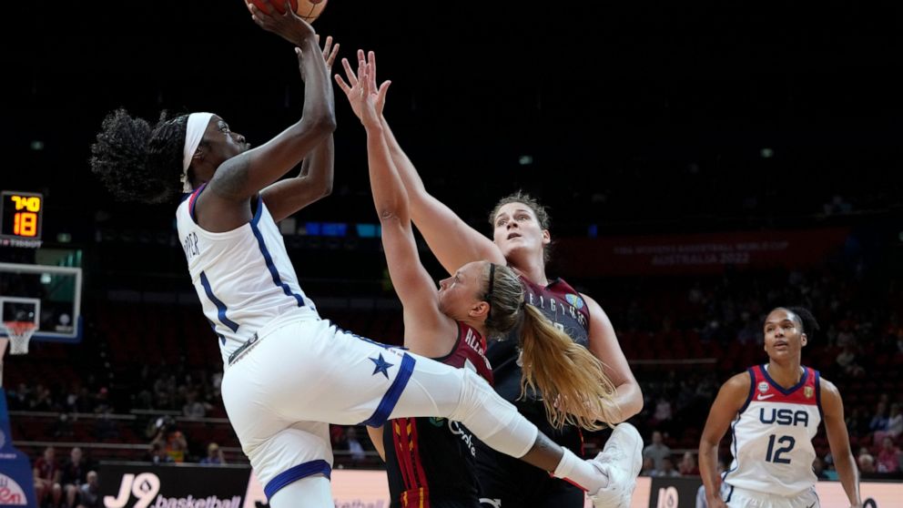 United States' Kahleah Copper, left, shoots over Belgium's Julie Allemand, second left, and Kyara Linskens during their women's Basketball World Cup game in Sydney, Australia, Thursday, Sept. 22, 2022. (AP Photo/Mark Baker)
