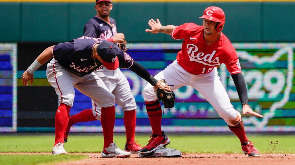 Cincinnati Reds' Nick Senzel (15) steals second base during the first inning of a baseball game against the Washington Nationals, Sunday, June 5, 2022, in Cincinnati. (AP Photo/Jeff Dean)