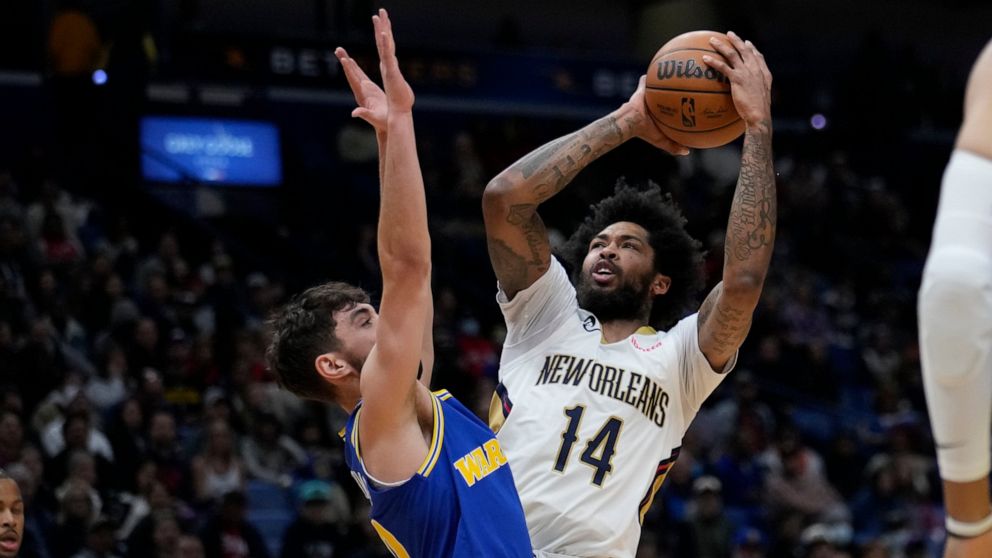 New Orleans Pelicans forward Brandon Ingram (14) shoots against Golden State Warriors guard Ty Jerome in the first half of an NBA basketball game in New Orleans, Monday, Nov. 21, 2022. (AP Photo/Gerald Herbert)