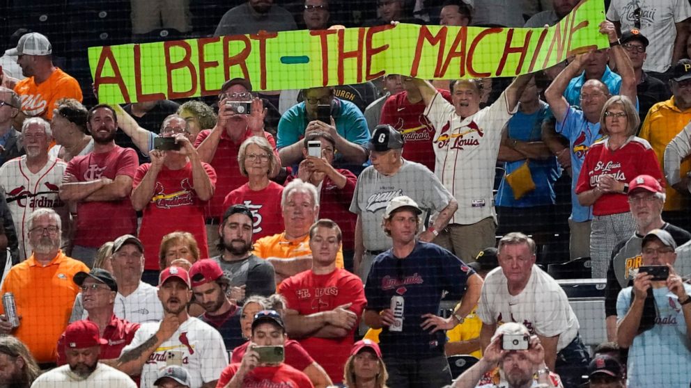 St. Louis Cardinals fans hold up a sign for Albert Pujols as he comes to bat against the Pittsburgh Pirates during the eighth inning of a baseball game Friday, Sept. 9, 2022, in Pittsburgh. (AP Photo/Keith Srakocic)