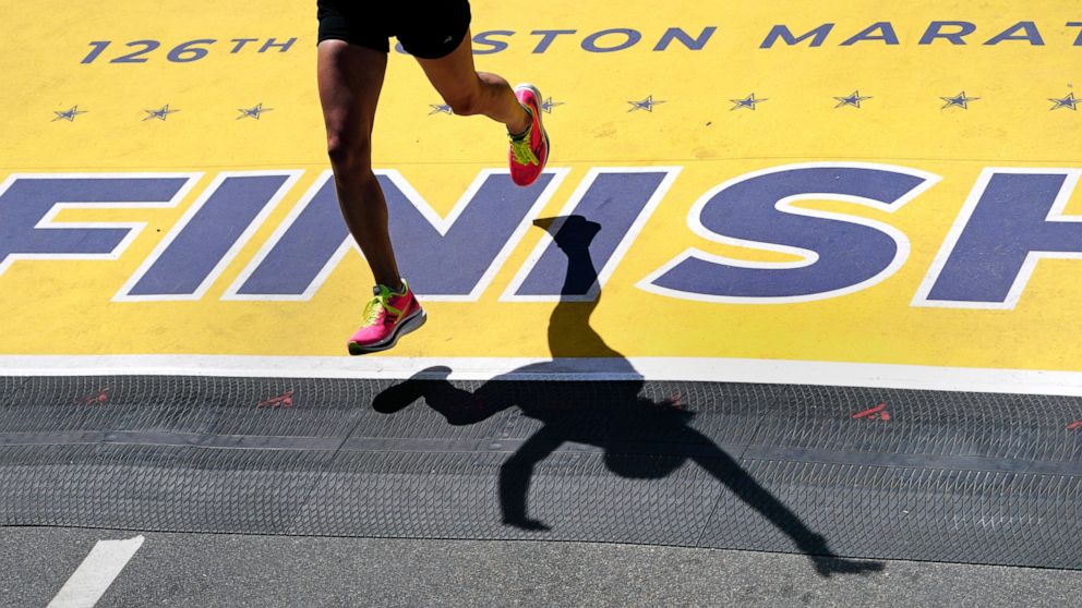 A runner crosses the finish line of the Boston Marathon, Monday, April 18, 2022, in Boston. (AP Photo/Charles Krupa)