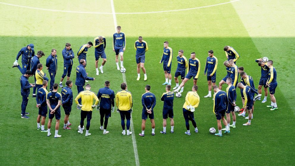 Ukraine players form a circle during a training session at the Cardiff City Stadium, Cardiff, Wales Saturday June 4, 2022, the day before the team play Wales in a World Cup play-off soccer match. (Mike Egerton/PA via AP)