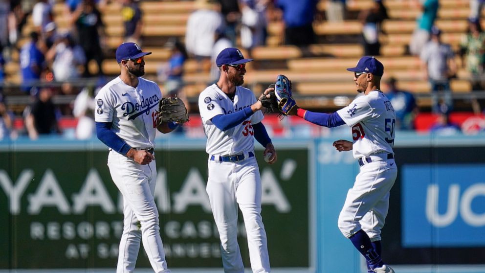 From left to right, Los Angeles Dodgers' Joey Gallo, Cody Bellinger and Mookie Betts celebrate a win in a baseball game against the St. Louis Cardinals, Sunday, Sept. 25, 2022, in Los Angeles. (AP Photo/Jae C. Hong)