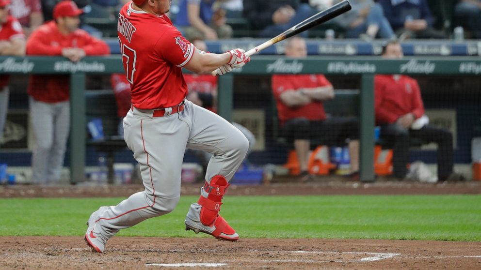 Los Angeles Angels' Mike Trout follows through on a two-run double during the fourth inning of the team's baseball game against the Seattle Mariners, Thursday, May 30, 2019, in Seattle. (AP Photo/Ted S. Warren)
