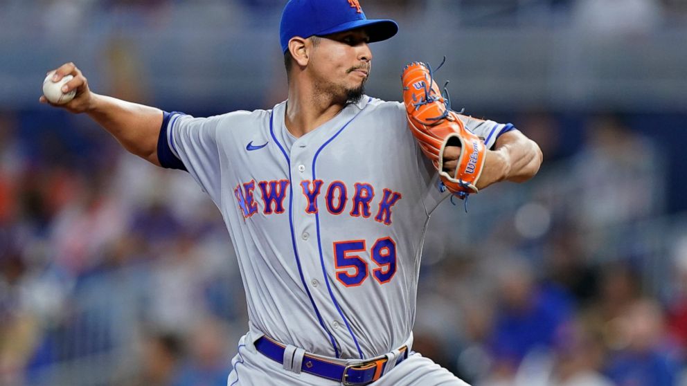 New York Mets' Carlos Carrasco delivers a pitch during the first inning of a baseball game against the Miami Marlins, Saturday, July 30, 2022, in Miami. (AP Photo/Wilfredo Lee)