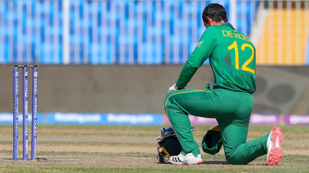 South Africa's Quinton de Kock kneels in support of the Black Lives Matter movement ahead of the Cricket Twenty20 World Cup match between South Africa and Sri Lanka in Sharjah, UAE, Saturday, Oct. 30, 2021. (AP Photo/Kamran Jebreili)