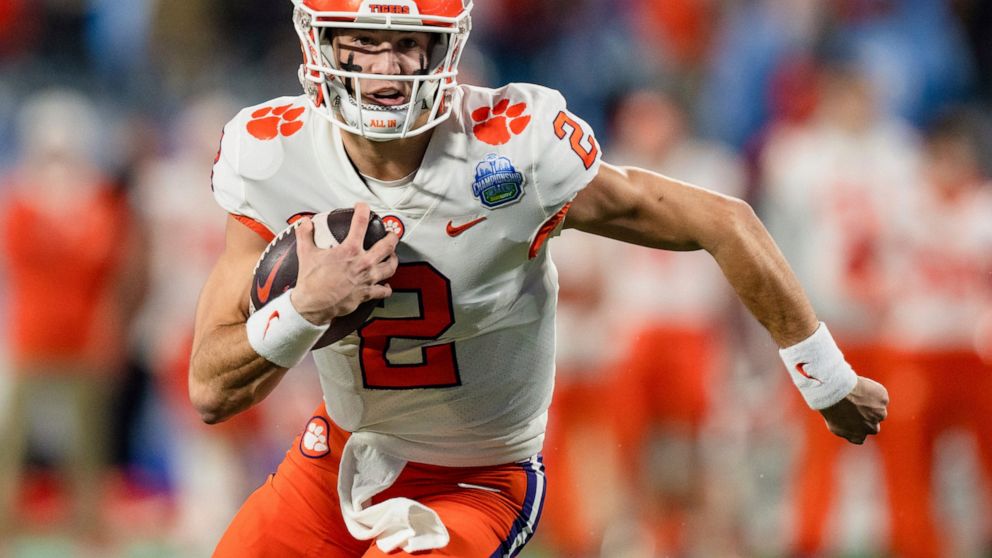Clemson quarterback Cade Klubnik runs with the ball in the first half during the Atlantic Coast Conference championship NCAA college football game against North Carolina on Saturday, Dec. 3, 2022, in Charlotte, N.C. (AP Photo/Jacob Kupferman)