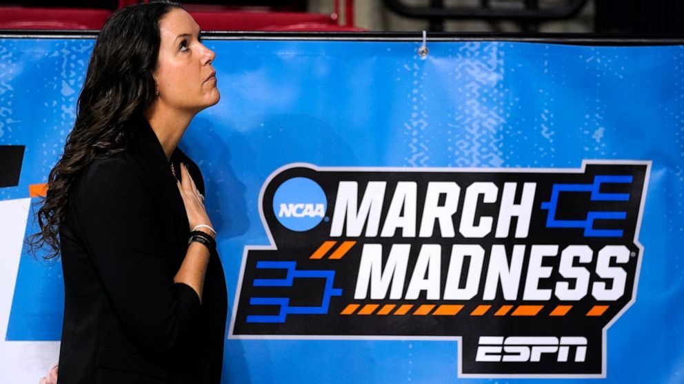 Dayton head coach Shauna Green looks on during the national anthem before a first-round game against Georgia in the NCAA women's college basketball tournament, Friday, March 18, 2022, in Ames, Iowa. The phrase “March Madness” is everywhere this women