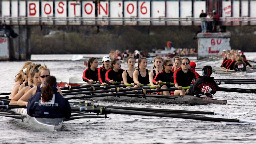 FILE - Competitors head to the starting line for Collegiate Women's Eights during the Head of the Charles Regatta in Cambridge, Mass., Sunday, Oct. 22, 2006. This month marks the 50th anniversary of the Title IX law that requires equitable treatment 
