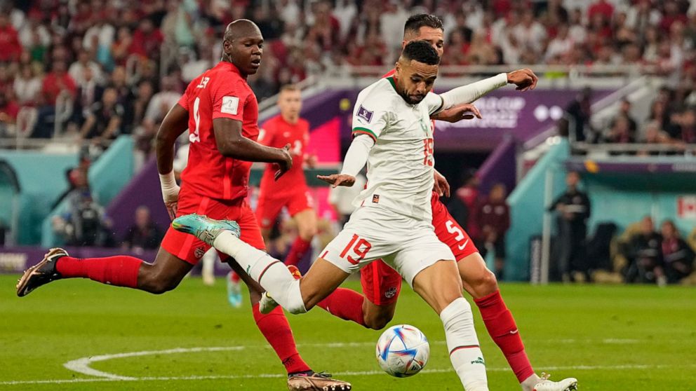 Morocco's Youssef En-Nesyri scores his side's second goal during the World Cup group F soccer match between Canada and Morocco at the Al Thumama Stadium in Doha , Qatar, Thursday, Dec. 1, 2022. (AP Photo/Pavel Golovkin)