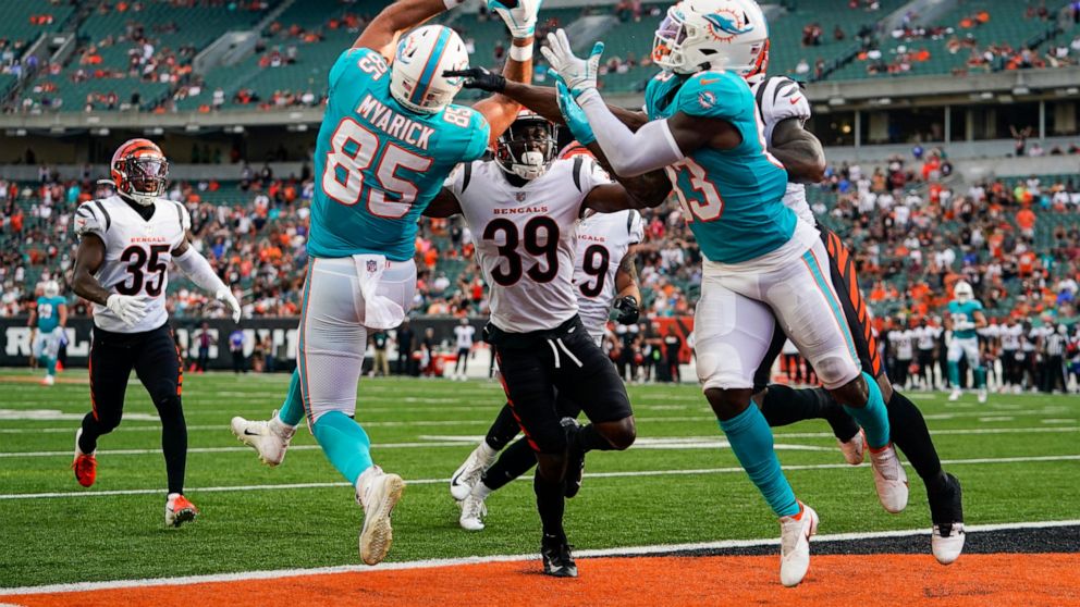 Miami Dolphins tight end Chris Myarick (85) makes a catch for a touchdown over Cincinnati Bengals defensive back Winston Rose (39) in the second half of an NFL exhibition football game in Cincinnati, Sunday, Aug. 29, 2021. (AP Photo/Bryan Woolston)