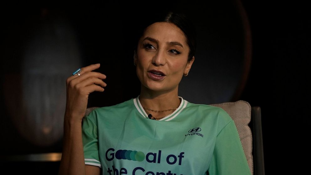 Nadia Nadim gestures as she speaks during an interview with The Associated Press in Doha, Qatar, Thursday, Dec. 1, 2022. Danish women's national team player Nadia Nadim was about to settle in for her job as a television commentator at the World Cup w