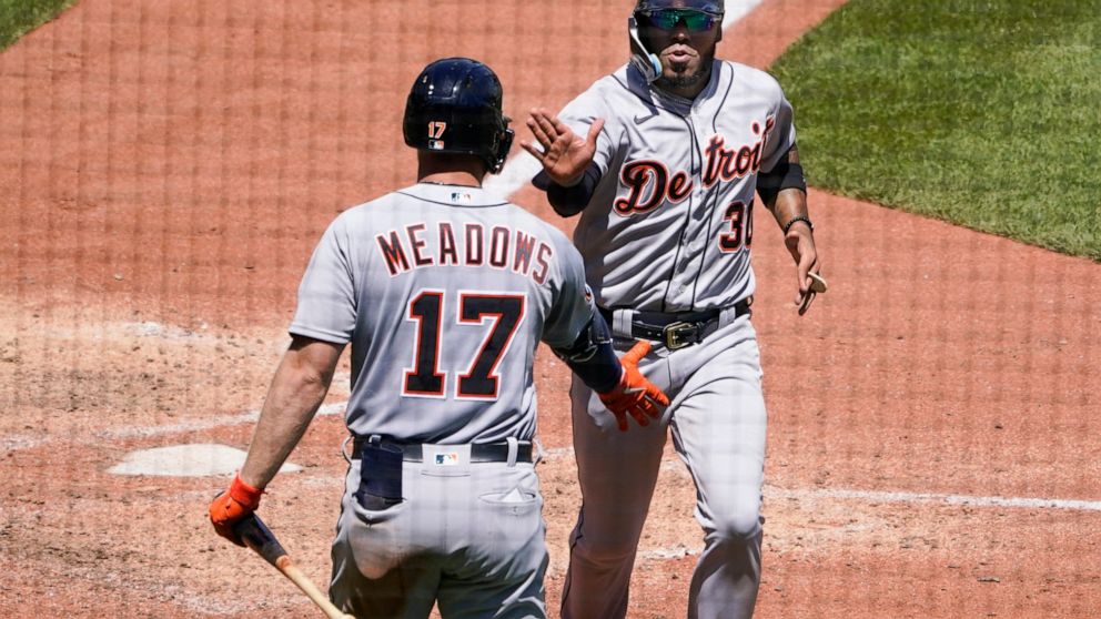 Detroit Tigers' Harold Castro, right, is greeted by Austin Meadows (17) after scoring against the Pittsburgh Pirates on a single by Miguel Cabrera during the eighth inning of a baseball game, Wednesday, June 8, 2022, in Pittsburgh. (AP Photo/Keith Sr