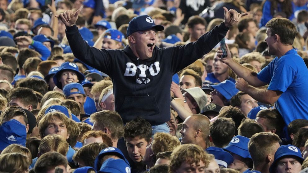 BYU fans storm the field and celebrate BYU's overtime win over Baylor after an NCAA college football game, Saturday, Sept. 10, 2022, in Provo, Utah. (AP Photo/George Frey)