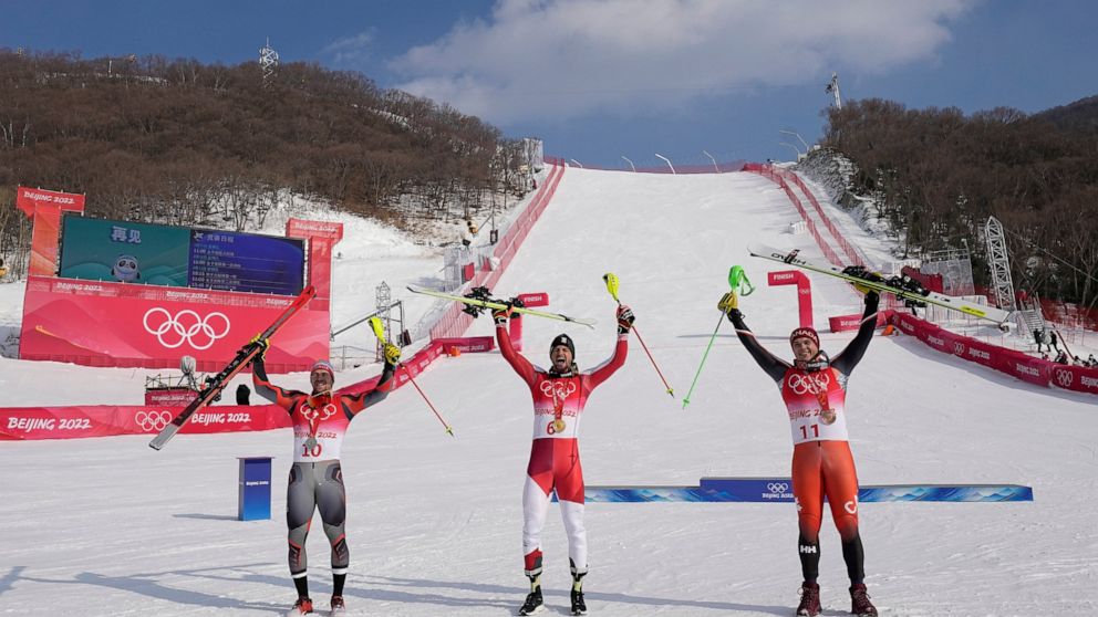 From left: Aleksander Aamodt Kilde, of Norway, silver, Johannes Strolz, of Austria, gold, and James Crawford, of Canada, bronze, celebrate during the medal ceremony for the the men's combined at the 2022 Winter Olympics, Thursday, Feb. 10, 2022, in t