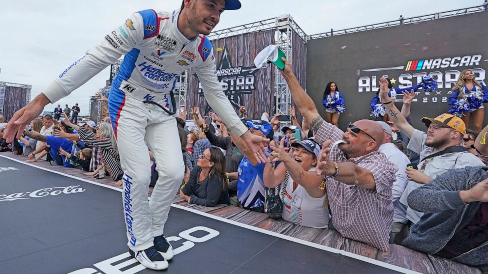 Kyle Larson reaches to fans during driver introductions before the NASCAR All-Star auto race at Texas Motor Speedway in Fort Worth, Texas, Sunday, May 22, 2022. (AP Photo/LM Otero)