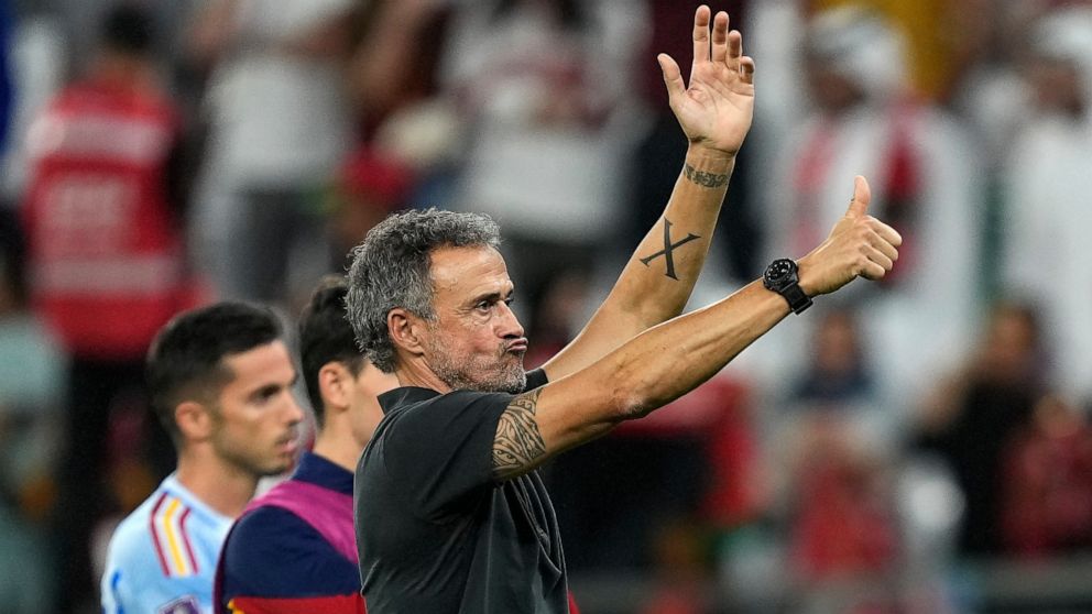 Spain's head coach Luis Enrique reacts to supporters at the end of the World Cup round of 16 soccer match between Morocco and Spain, at the Education City Stadium in Al Rayyan, Qatar, Tuesday, Dec. 6, 2022. (AP Photo/Martin Meissner)