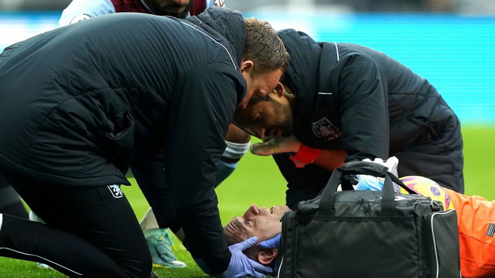 Aston Villa goalkeeper Emiliano Martinez receives treatment during the English Premier League soccer match between Newcastle United and Aston Villa at St. James' Park, Newcastle, England, Saturday, Oct. 29, 2022. (Owen Humphreys/PA via AP)