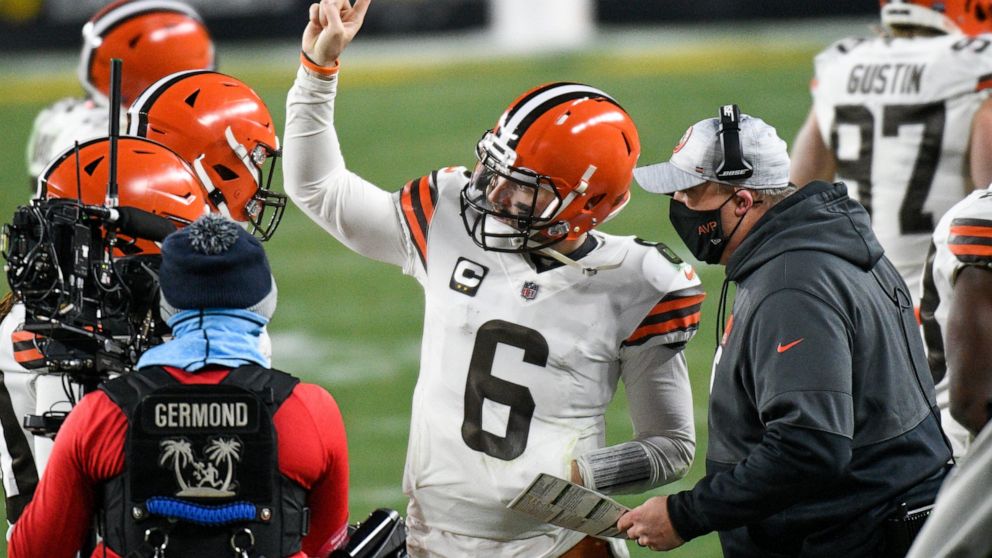 Cleveland Browns offensive coordinator Alex Van Pelt, right, talks with quarterback Baker Mayfield (6) on the sideline during the second half of an NFL wild-card playoff football game against the Pittsburgh Steelers in Pittsburgh, Sunday, Jan. 10, 20