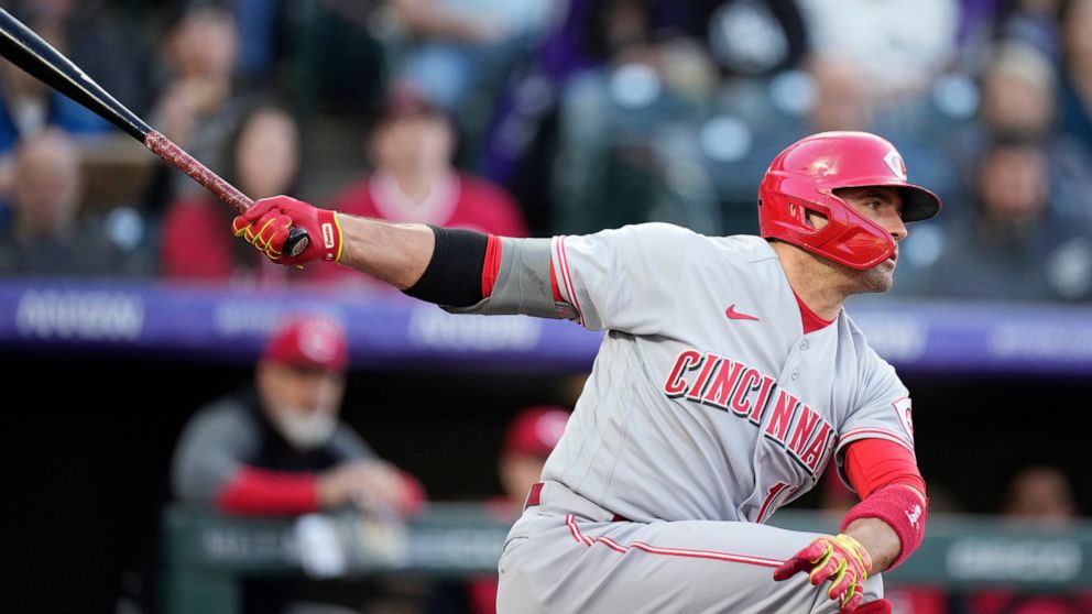 Cincinnati Reds' Joey Votto strikes out against Colorado Rockies starting pitcher Chad Kuhl in the fourth inning of a baseball game Saturday, April 30, 2022, in Denver. (AP Photo/David Zalubowski)