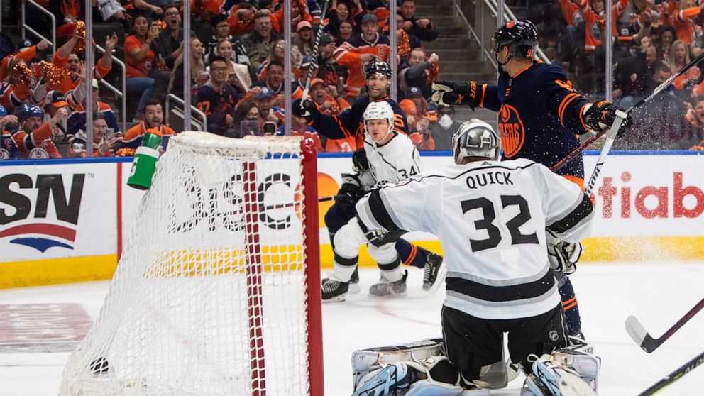 Los Angeles Kings' goalie Jonathan Quick (32) gives up a goal to Edmonton Oilers' Darnell Nurse (25) during the second period of Game 2 of an NHL hockey Stanley Cup playoffs first-round series Wednesday, May 4, 2022, in Edmonton, Alberta. (Jason Fran